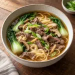 Beef noodle soup served in a ceramic bowl