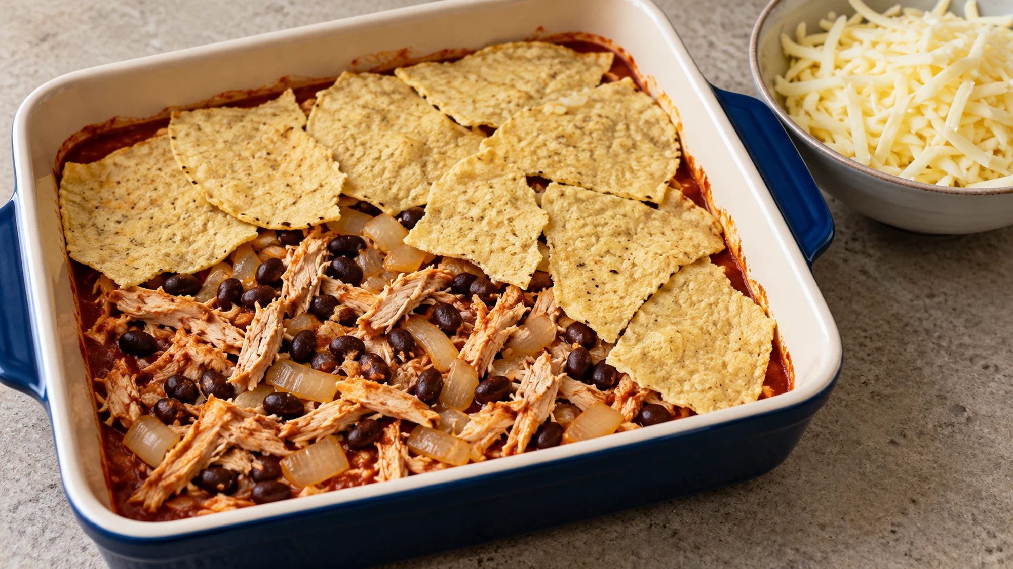 chicken enchilada casserole cooking in the pan