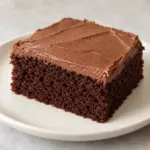 Chocolate cake recipe slice with a thin cocoa buttercream layer