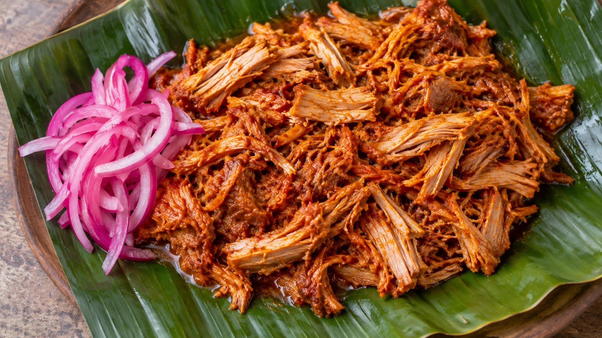 Close view of citrus-achiote pork in cochinita pibil