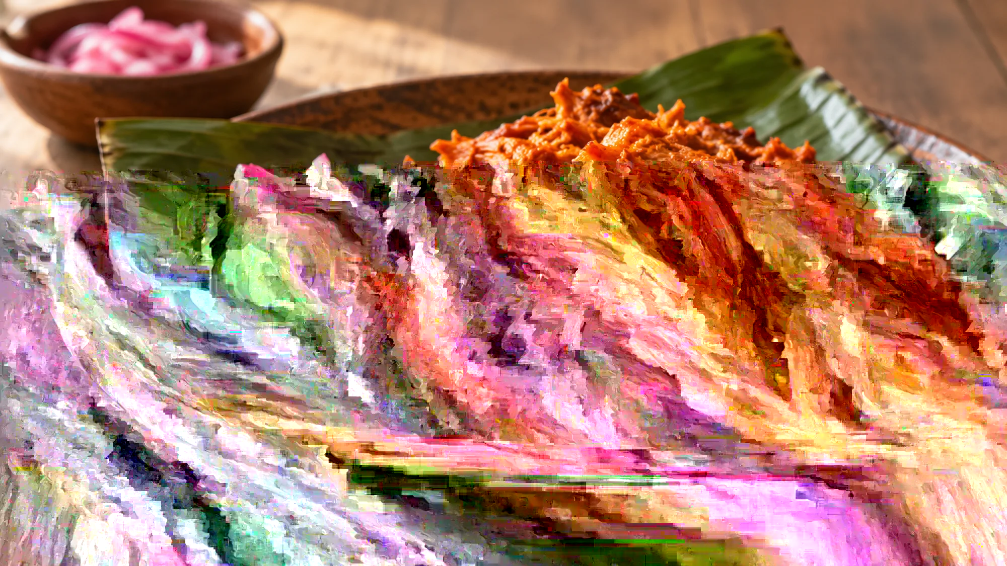 Shredded cochinita pibil with pickled red onions