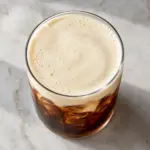 Overhead view of the cold foam recipe topping iced coffee