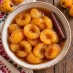dulce de tejocote with pitted fruit halves and cinnamon, overhead
