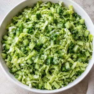 Overhead green goddess cabbage salad coated in yogurt and tahini herb dressing