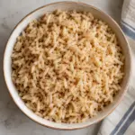 Plain cooked grains in a bowl illustrating how to cook brown rice