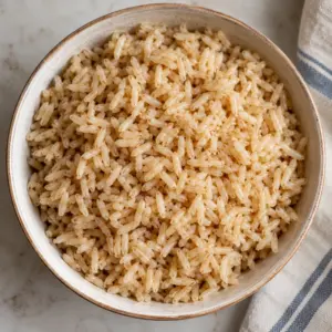 Plain cooked grains in a bowl illustrating how to cook brown rice