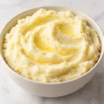 Bowl of mashed potatoes with gentle spoon swirls