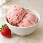 Strawberry banana low calorie ice cream scoops with tiny fruit flecks