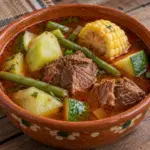 Close view of mole de olla with tender beef and corn