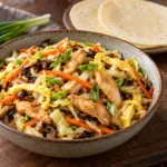 Bowl of moo shu chicken with thin pancakes