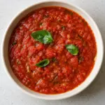 Bowl of chunky pomodoro sauce with basil leaves