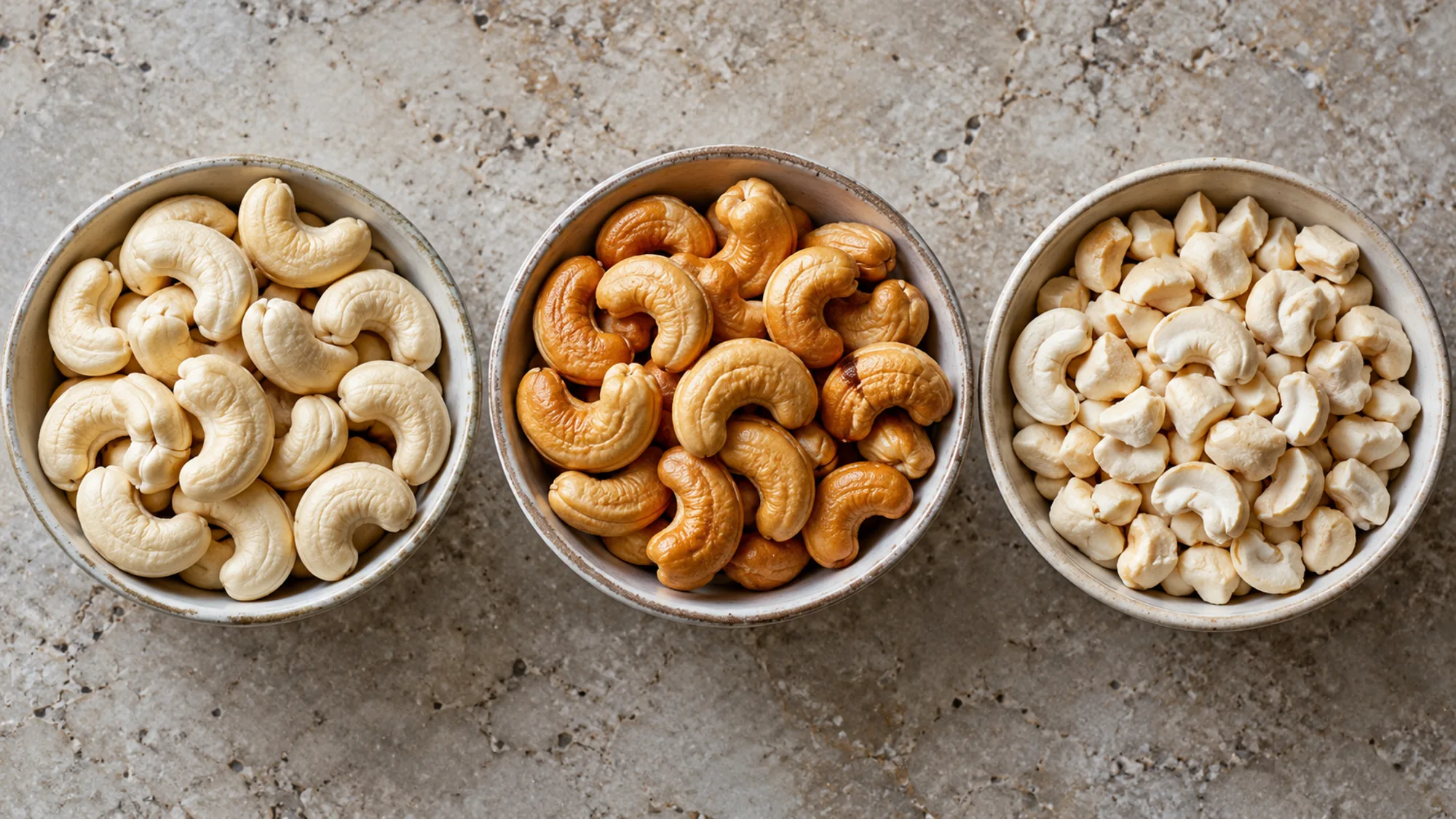 Unroasted cashews, golden toasted cashews and broken cashew pieces