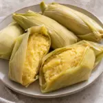 Tender uchepos with sweet-corn filling inside fresh husk wrappers