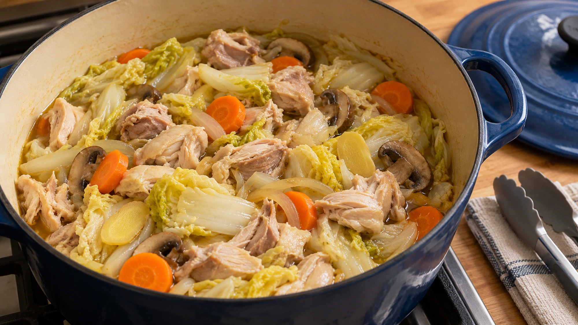Cooked chicken pieces returned to a pot of waterless chicken and cabbage soup