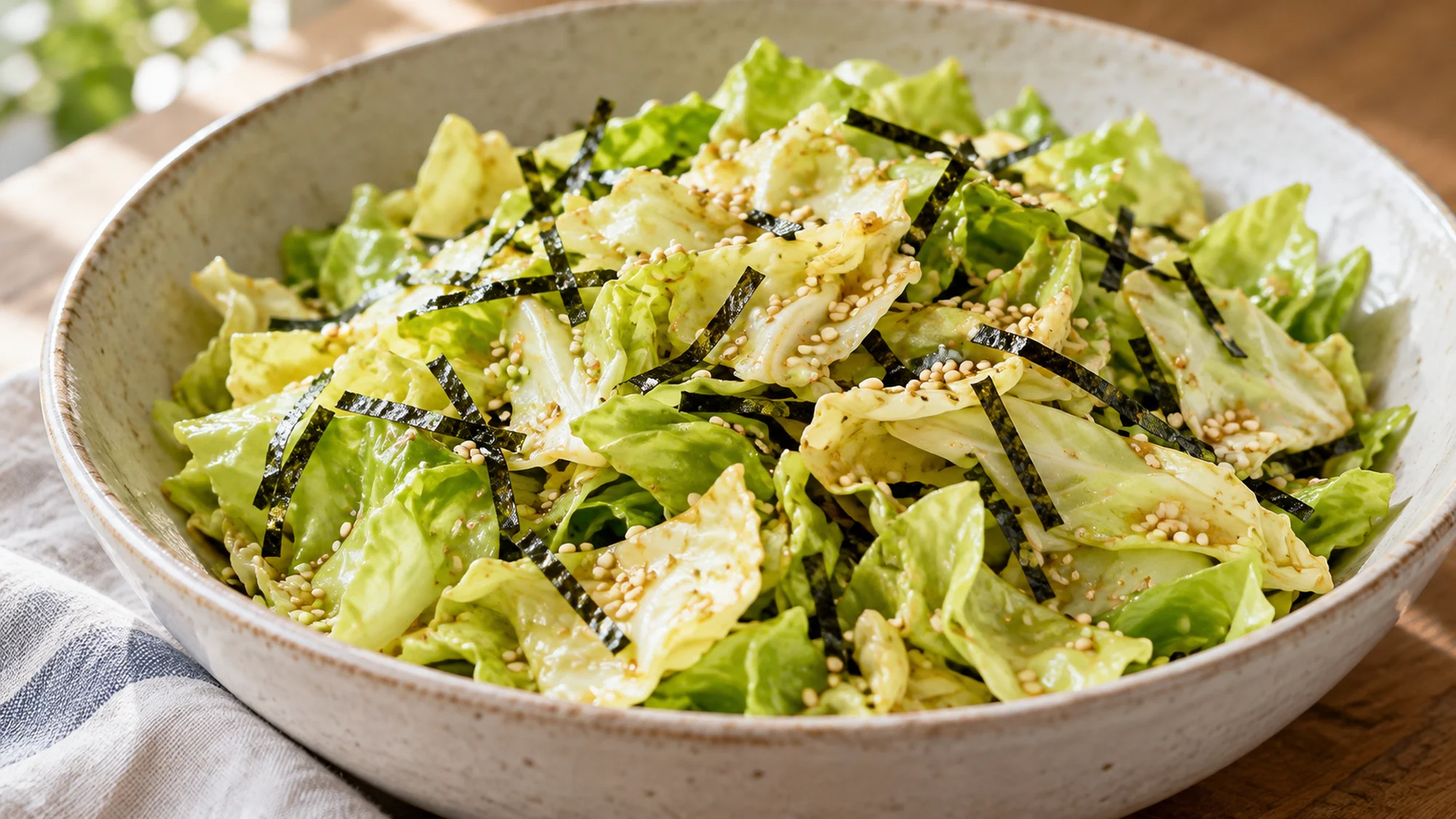 Torn raw cabbage coated with sesame dressing and nori